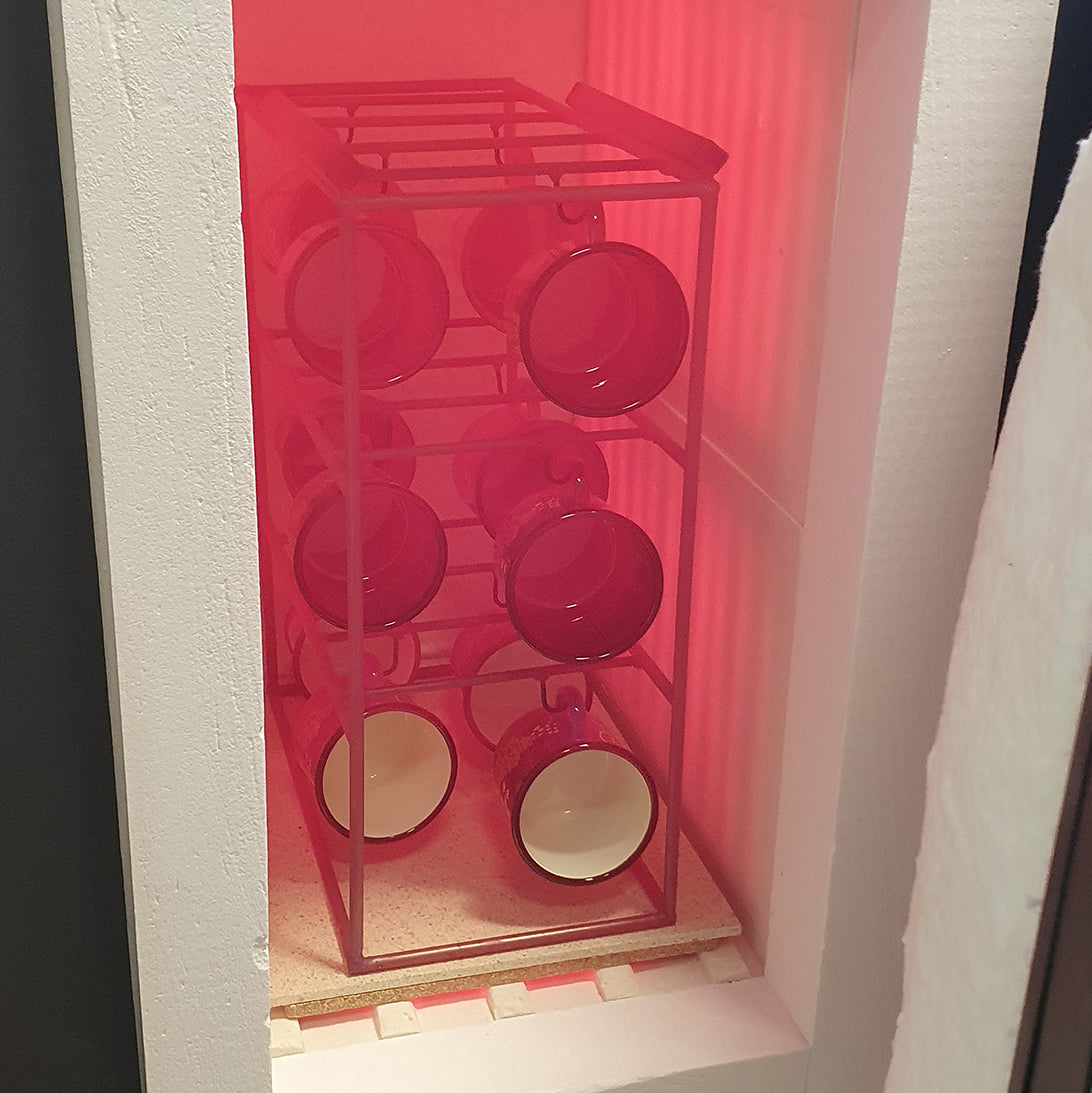 custom printed enamel mugs firing in the industrial kiln